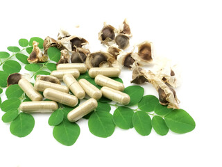 Moringa capsules and pods, isolated on white background .Herbs, with antioxidants.