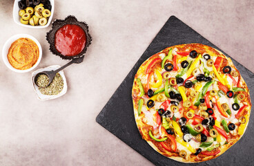 Delicious vegetable pizza with sauce and olives