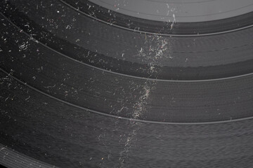 Close-up shot of LP vinyl record groove with dust and dirt