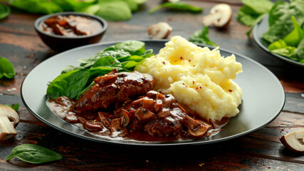 Salisbury Steak with mushroom gravy, mashed potatoes and spinach