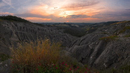Badlands and rossena castle at sunset