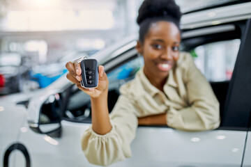 close-up photo of black female hands holding car keys, attractive happy woman buy white automobile, smile at camera