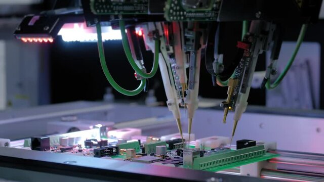 Automated technology, industrial, robotic, electronic, production, manufacturing concept. Automation machine equipment for quality testing of printed circuit boards - flying probe test - close up