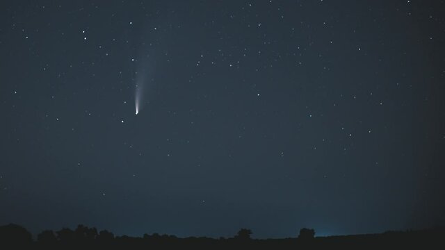 Comet NEOWISE moves across the night sky among the stars. Timelapse 4K
