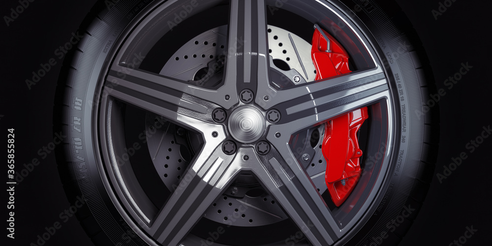 Wall mural car wheel with red breaks on black background.