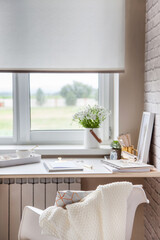 Work table near the window in the Scandinavian Nordic style. Female work and home office concept....