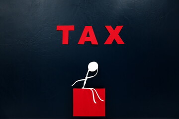 Worried human stick figure sitting with red TAX word cutout. Tax burden concept.