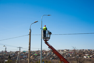 Electricians repairing wire of the power line