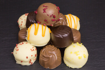 heap of different white and dark chocolate truffles