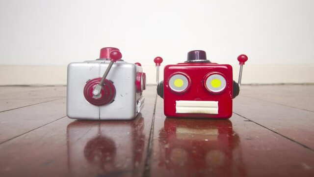 two robot heads chatting on a wooden floor with reflection 