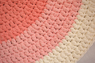 Round pink handmade rug.Crocheting from knitted yarn.