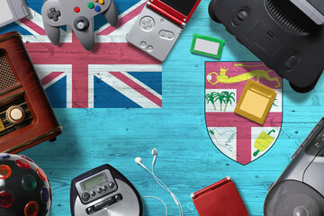 Fiji retro gaming concept. A collection of retro video game controllers shot from above on a national background.
