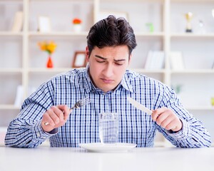 Man on diet waiting for food in restaurant