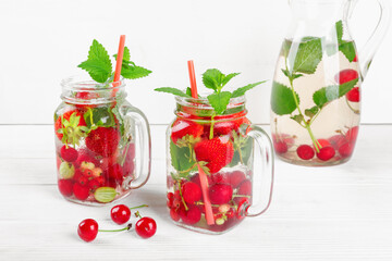 Fresh cool drink of ripe juicy cherry, strawberry, currant and gooseberry berries