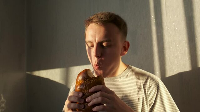 Hungry poor man eating bread or loaf