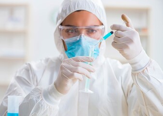 Young chemist student working in lab on chemicals