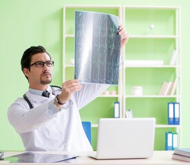 Doctor radiologist looking at x-ray scan in hospital