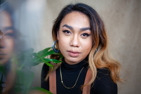 Portrait through crystal quartz of a young nonbinary adult, Asian Filipino