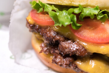 Double cheeseburger with tomato lettuce and onion, Cheese Fries and Milkshake.