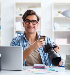 Young photographer working with his camera