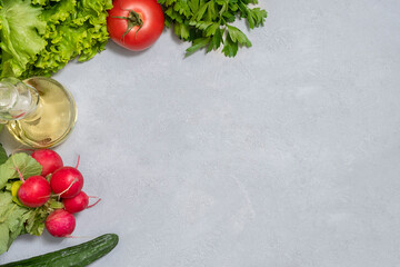 Fototapeta na wymiar Fresh raw salad ingredients on neutral concrete background with copy space, top view