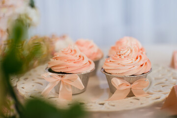 Cupcakes with pink frosting on a party table