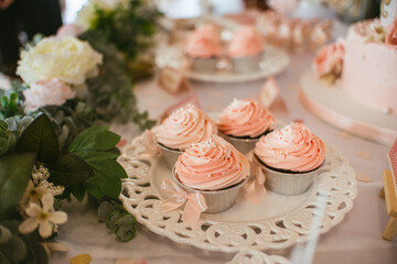 Cupcakes with pink frosting on a party table