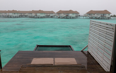 Wooden jetty at cloudy sea.