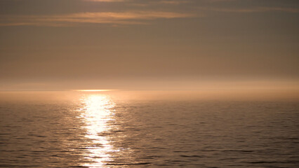 Fototapeta premium Yellow sunset over the sea
