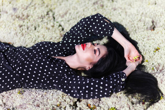 Woman laying on a dry moss