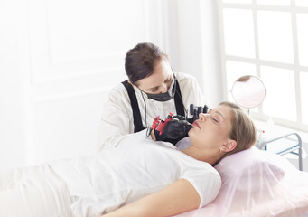 Cosmetologist applying permanent make up on eyebrows