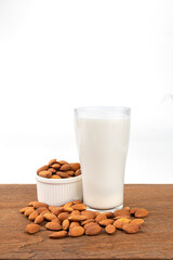 Close Up glass of Almond milk with Almond seeds.  on white background