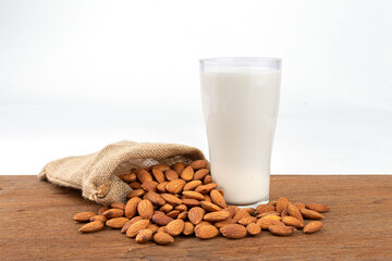Close Up glass of Almond milk with Almond seeds.  on white background