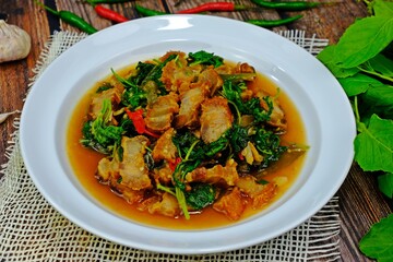 Stir fried spicy crispy pork belly with Thai basil. Authentic Thai food.