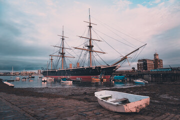 HMS Warrior moored in Portsmouth with an old fishing boat in the foreground © Seadog81