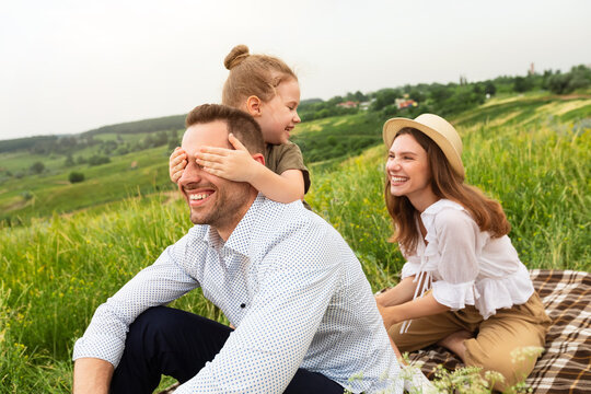 Happy Young Family Playing Together On A Picnic