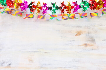 Fototapeta na wymiar Colorful chain garland over white wooden background. Traditional jewish sukkot holiday decoration