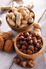 Composition with two bowls of hazelnuts and peanuts