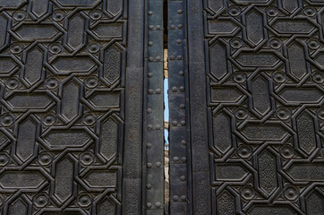 Wooden door called Door of Forgiveness in Seville Cathedral, Spain