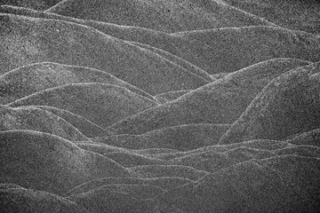 Closeup wave markings on sand resembling mountains
