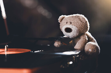 Still life wiith shafts of morning light stream through lonely teddy bear sitting on spinning...