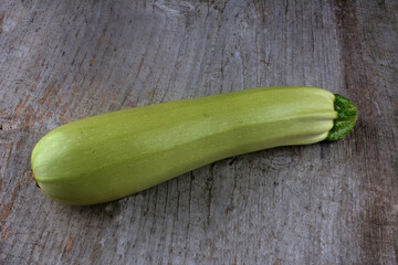 Homegrown zucchini on vintage table.The prepared organic zucchini is placed on the cutting board,