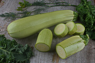 Homegrown zucchini on vintage table.The prepared organic zucchini is placed on the cutting board,