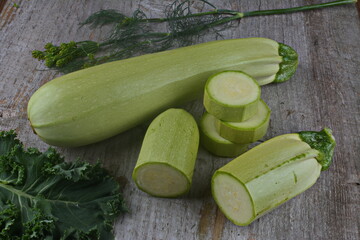 Homegrown zucchini on vintage table.The prepared organic zucchini is placed on the cutting board,