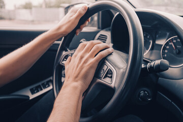 Naklejka premium angry driver presses the horn of the car to attract the attention of the car bully and avoid road accident. Stress and aggressive driving on city streets