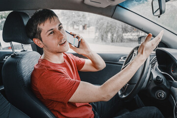 chatterbox driver is driving and talking to a friend on the phone at the same time. Creates a dangerous road situation and the risk of an accident due to distraction