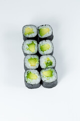 Japanese food. Rolls with ripe avocado, fresh rice with vegetables in nori. Vegetarian rolls