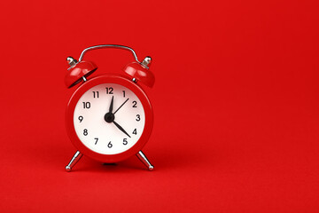 Close up one red alarm clock over red background