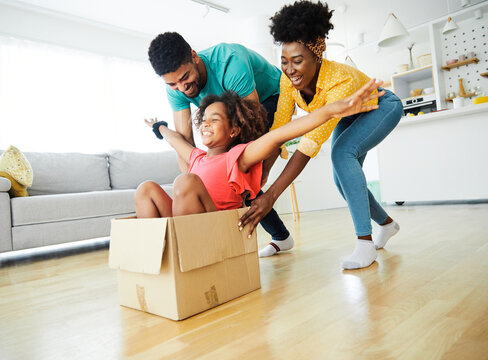 child family father fun mother happy girl happiness daughter box together relocation moving cardboard box