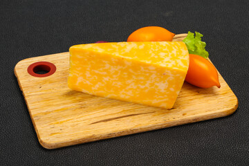 Marble cheese  triangle over wooden